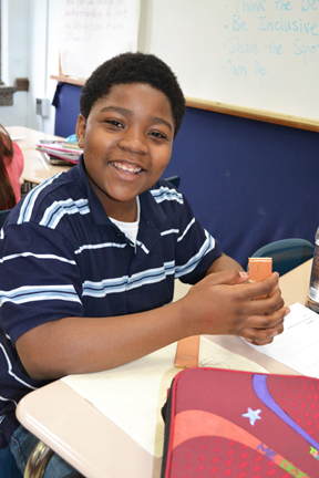 Middle school student works on his engineering design project.