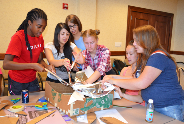 Group of campers from a joint session of GLAM and G-BAM assemble the framework for the solar oven they were collaborating on.