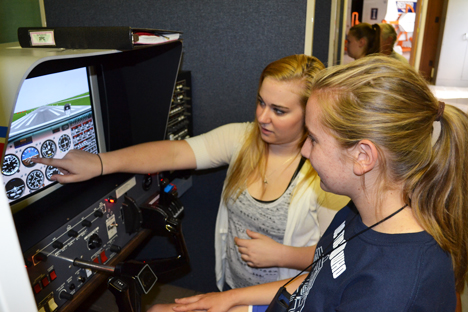 Flightstar instructor (left) shows a GAMES camper how to navigate while using the flight simulator.