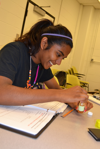 G.A.M.E.S. camper in the Environmental Engineering and Sustainability camp tests the purity of a water sample.