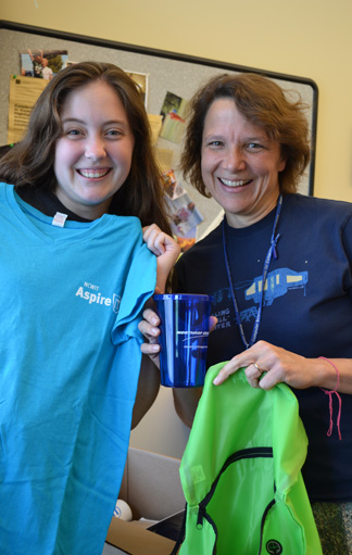 Briana Chapman and Cinda Heeren show off some of the goodies they received from the girls from NCWIT.