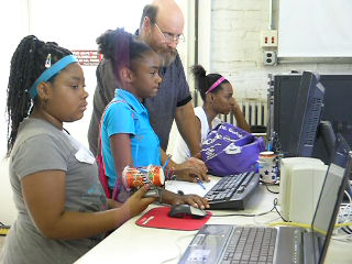 Volunteer worker assisting youth in Lab.